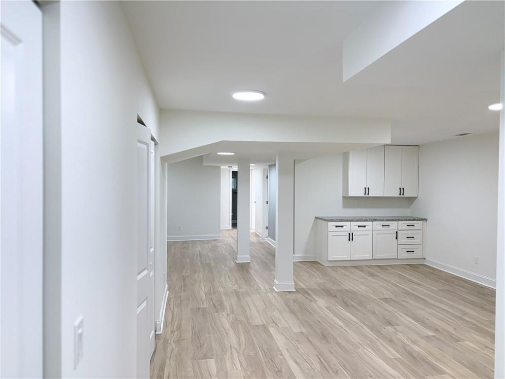 1110 Upper Hembree Road Roswell, GA 30076 - Photo 30 of 51 a view of kitchen and empty room with wooden floor