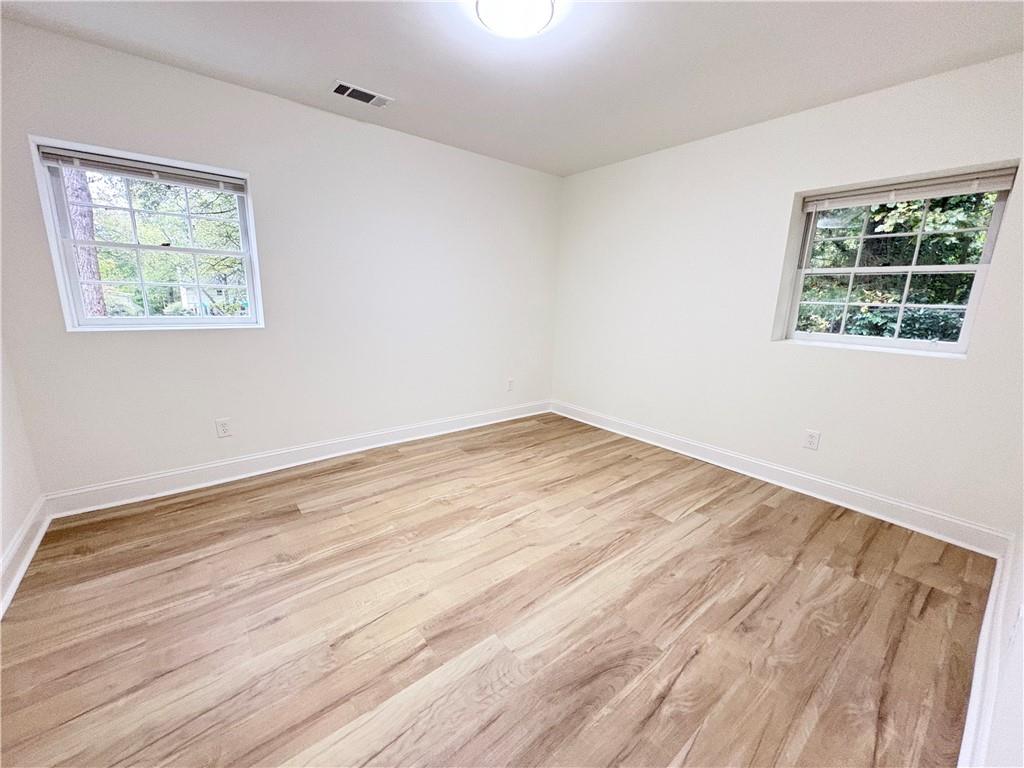 1110 Upper Hembree Road Roswell, GA 30076 - Photo 32 of 51 a view of empty room with wooden floor and fan