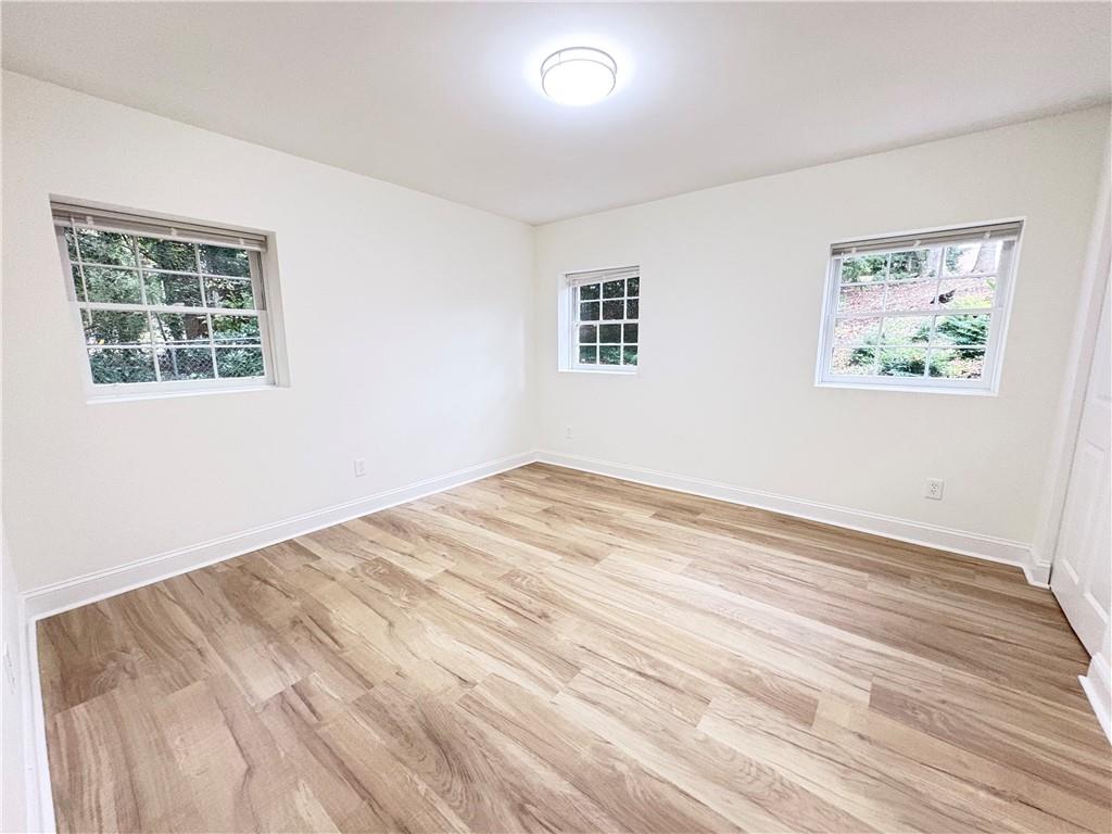 1110 Upper Hembree Road Roswell, GA 30076 - Photo 33 of 51 a view of empty room with wooden floor and window