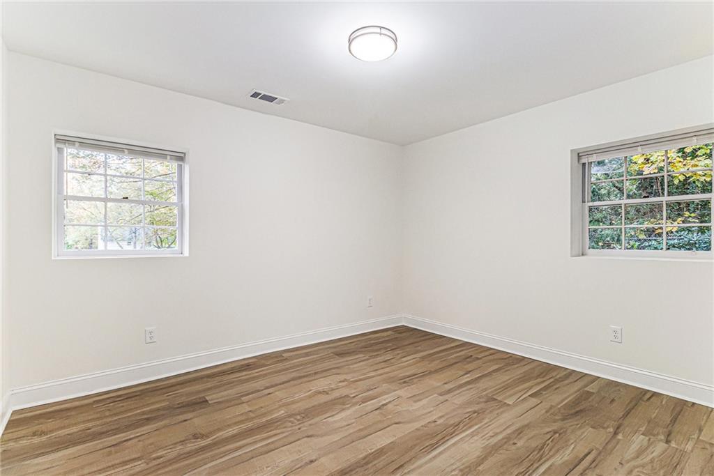 1110 Upper Hembree Road Roswell, GA 30076 - Photo 35 of 51 an empty room with wooden floor and windows