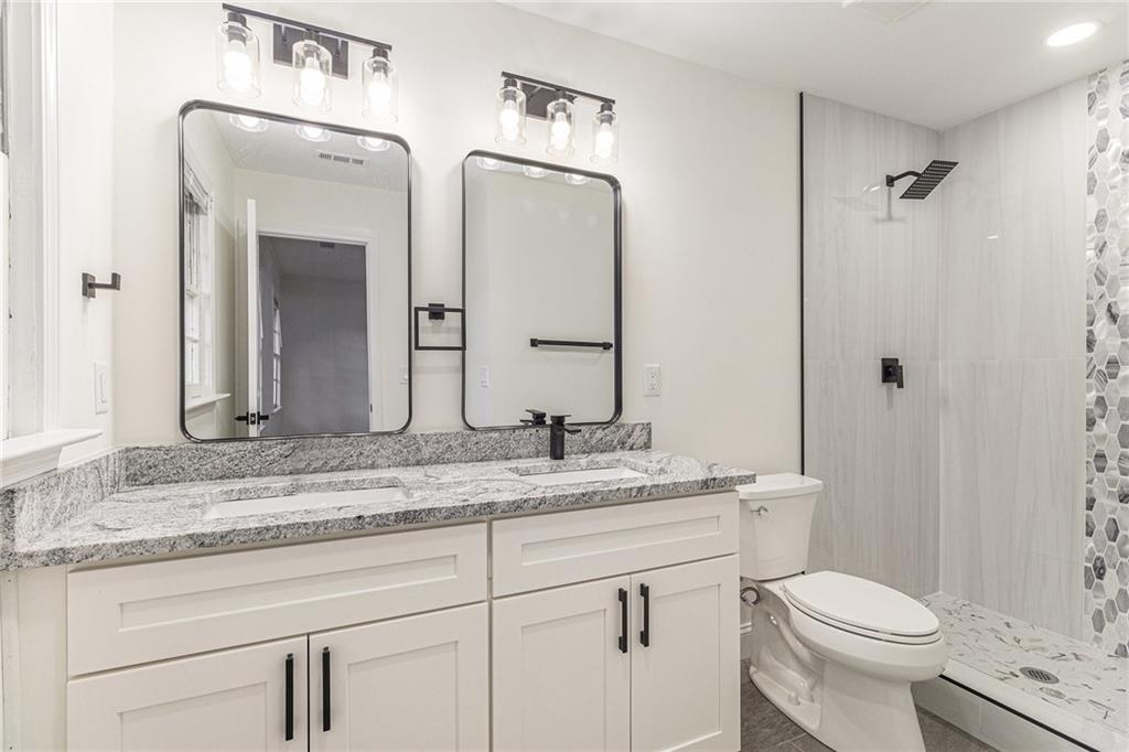 1110 Upper Hembree Road Roswell, GA 30076 - Photo 36 of 51 a bathroom with a granite countertop sink toilet and shower