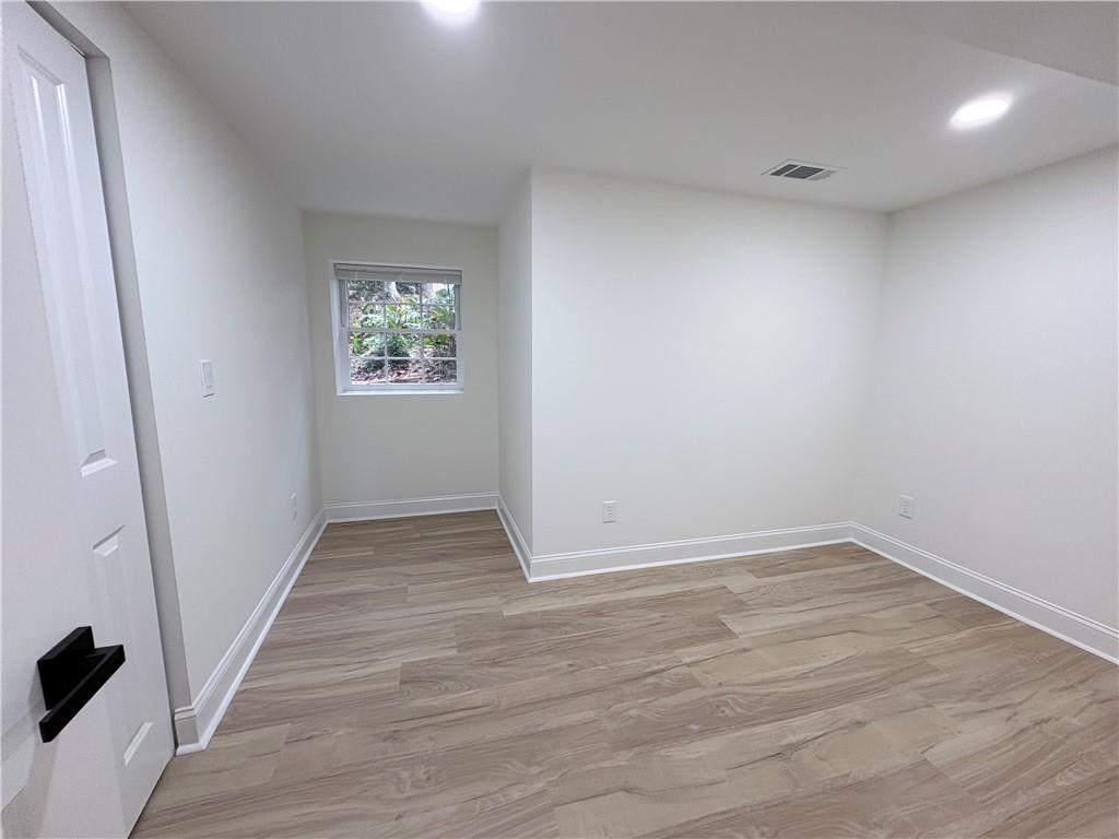 1110 Upper Hembree Road Roswell, GA 30076 - Photo 39 of 51 an empty room with wooden floor and windows
