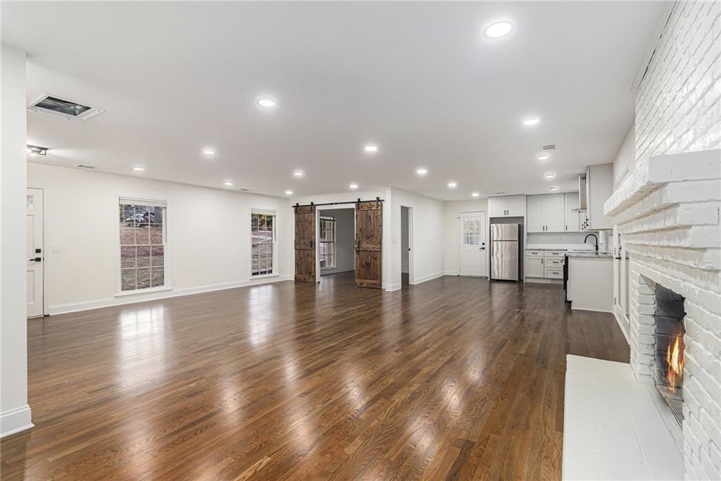 1110 Upper Hembree Road Roswell, GA 30076 - Photo 8 of 51 a view of a hallway with wooden floor and a kitchen