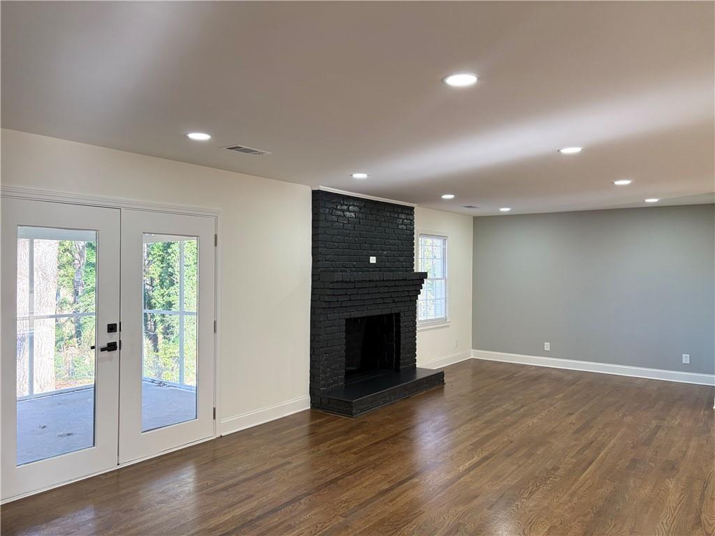 1110 Upper Hembree Road Roswell, GA 30076 - Photo 9 of 51 a view of an empty room with wooden floor and a window