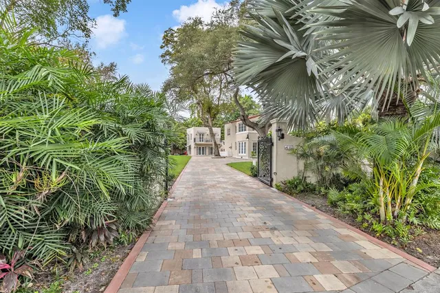 a kitchen with stainless steel appliances a sink cabinets and wooden floor