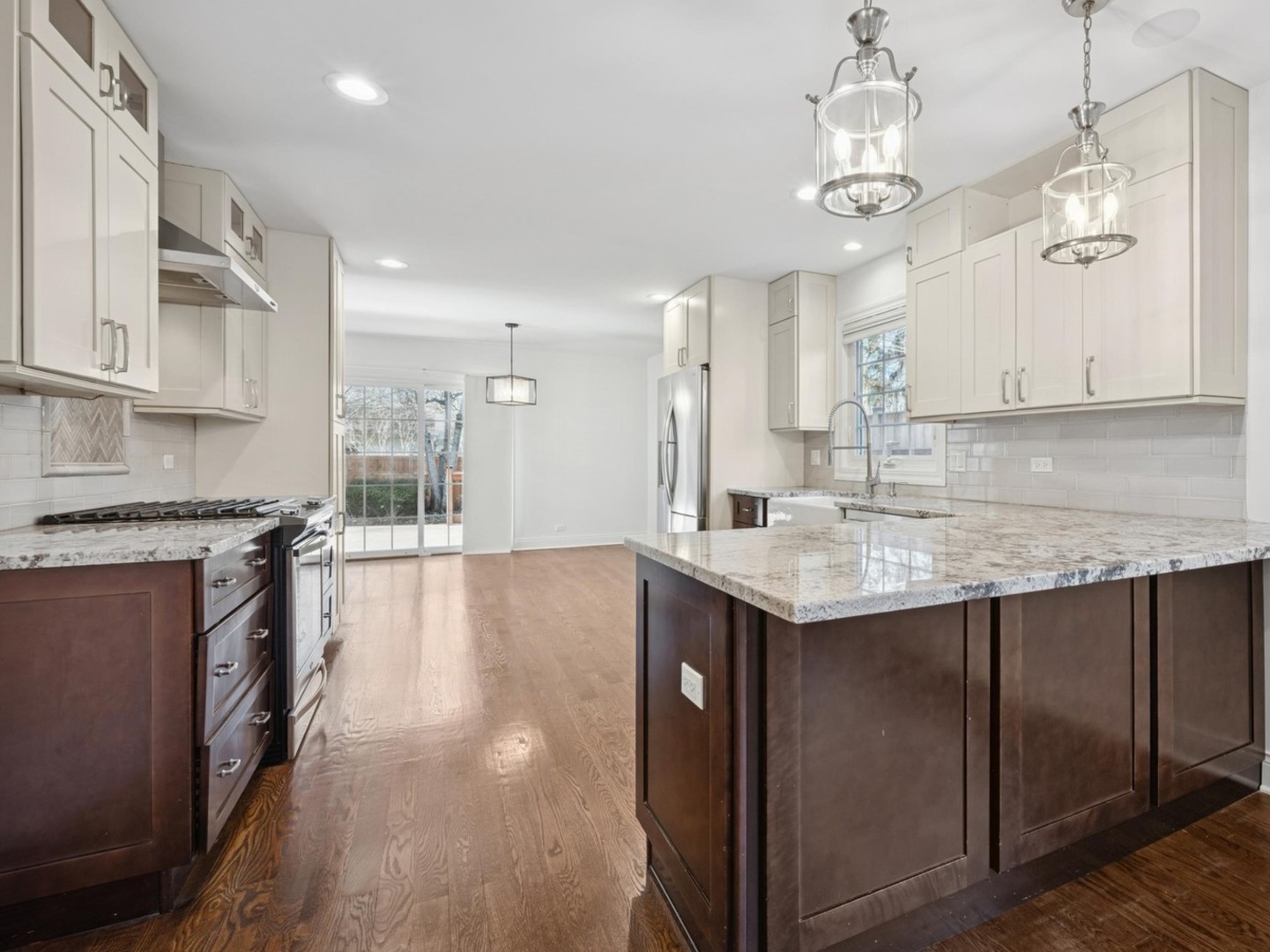 716 Indian Road Glenview, IL 60025 - Photo 11 of 32 a kitchen with stainless steel appliances granite countertop a sink stove and refrigerator