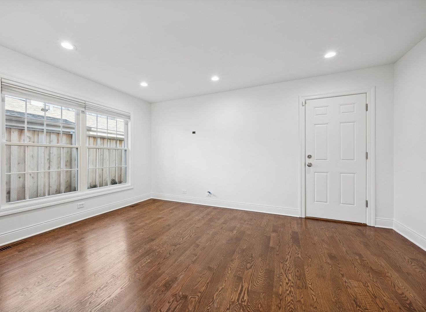 716 Indian Road Glenview, IL 60025 - Photo 12 of 32 an empty room with wooden floor and windows