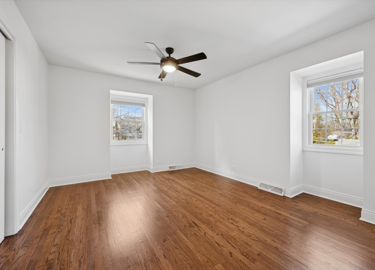 716 Indian Road Glenview, IL 60025 - Photo 19 of 32 a view of empty room with wooden floor and fan