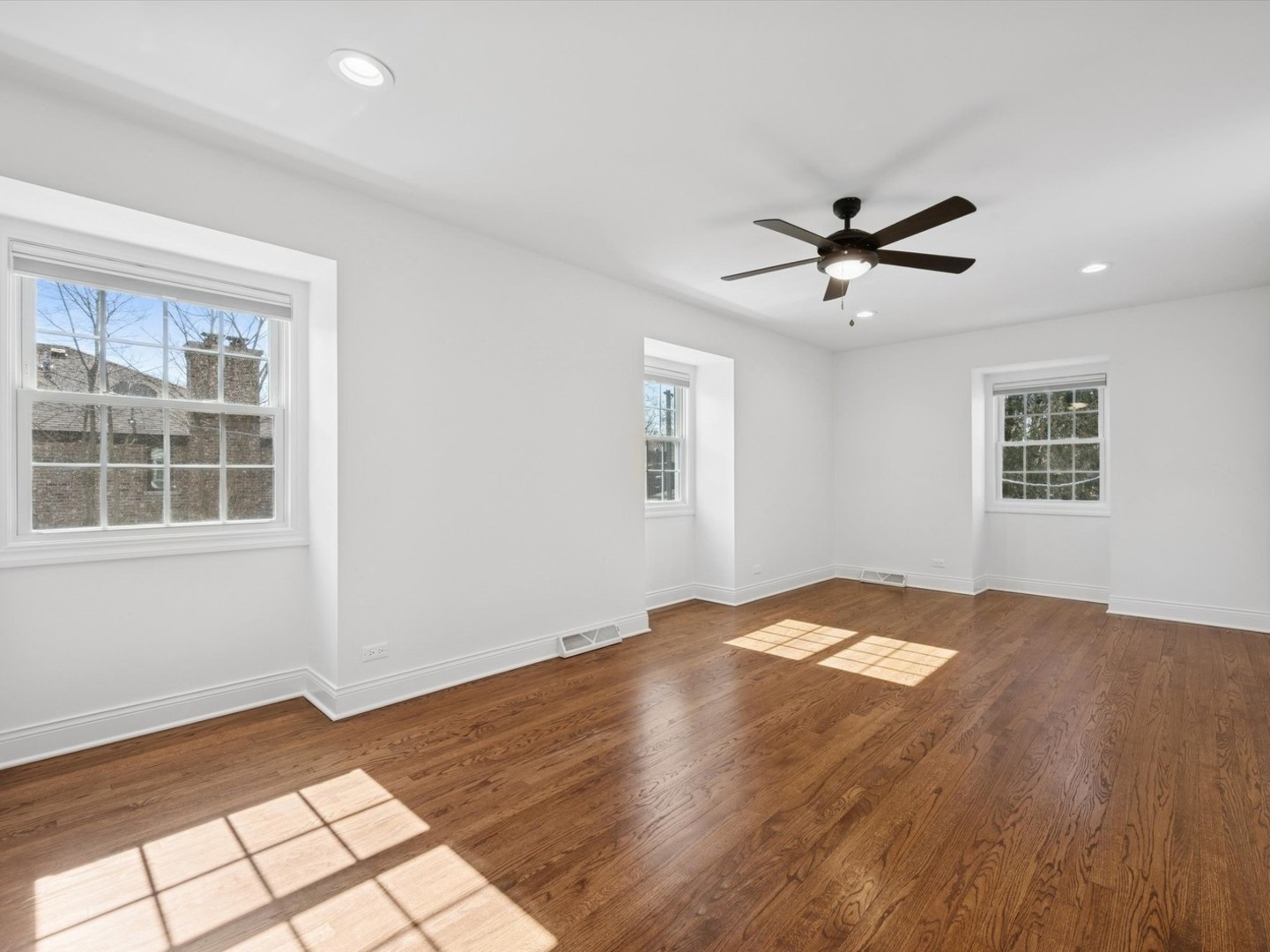716 Indian Road Glenview, IL 60025 - Photo 21 of 32 a view of a big room with wooden floor and windows