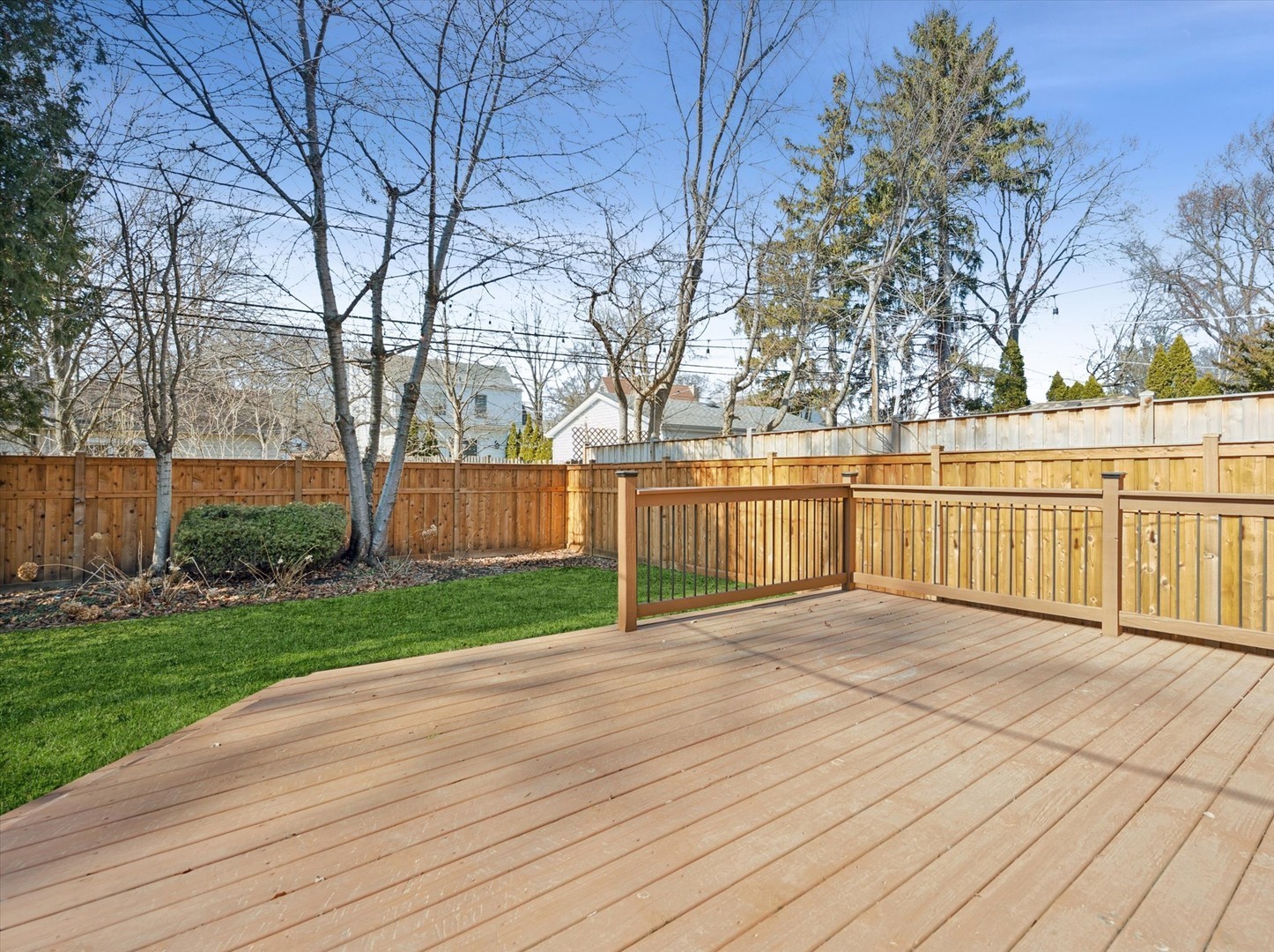 716 Indian Road Glenview, IL 60025 - Photo 29 of 32 a view of a deck with large trees and wooden fence