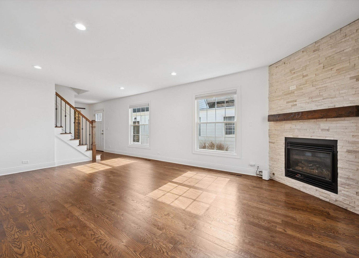 716 Indian Road Glenview, IL 60025 - Photo 3 of 32 a view of an empty room with wooden floor fireplace and a window