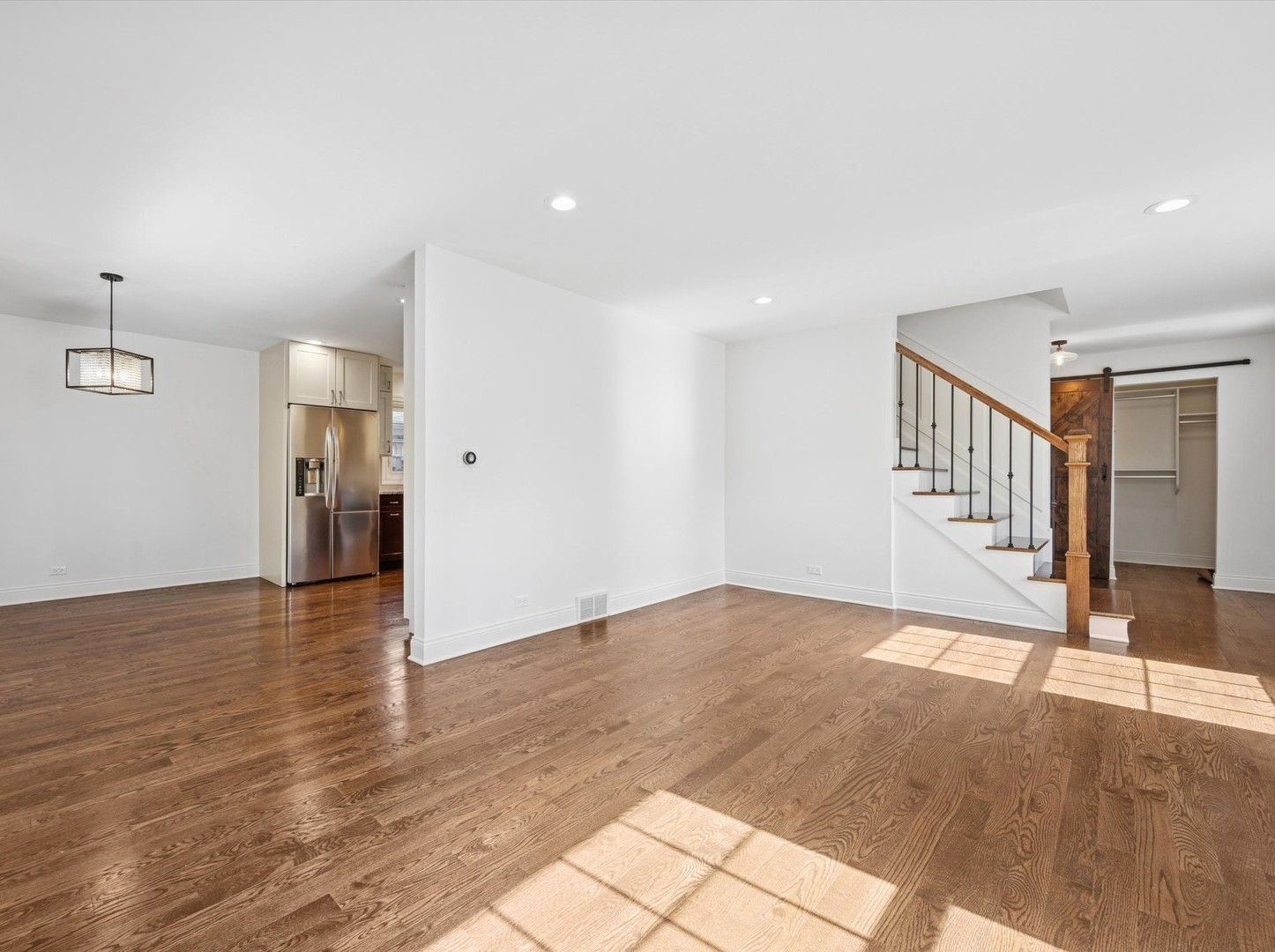716 Indian Road Glenview, IL 60025 - Photo 4 of 32 a view of an empty room with wooden floor and staircase