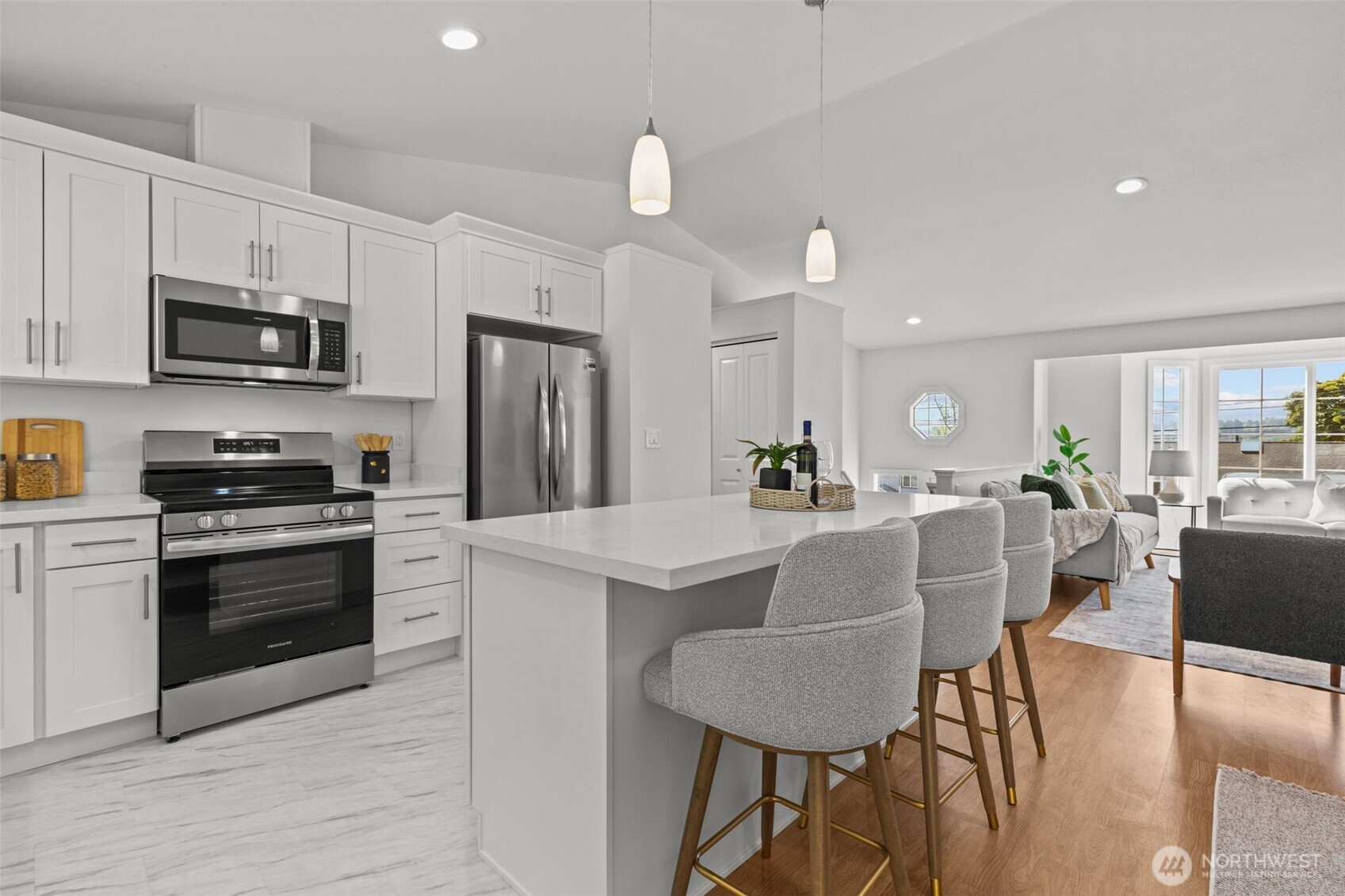 11822 56th Place South Seattle, WA 98178 - Photo 7 of 39 a kitchen with stainless steel appliances granite countertop a stove a refrigerator a kitchen island with a dining table and chairs