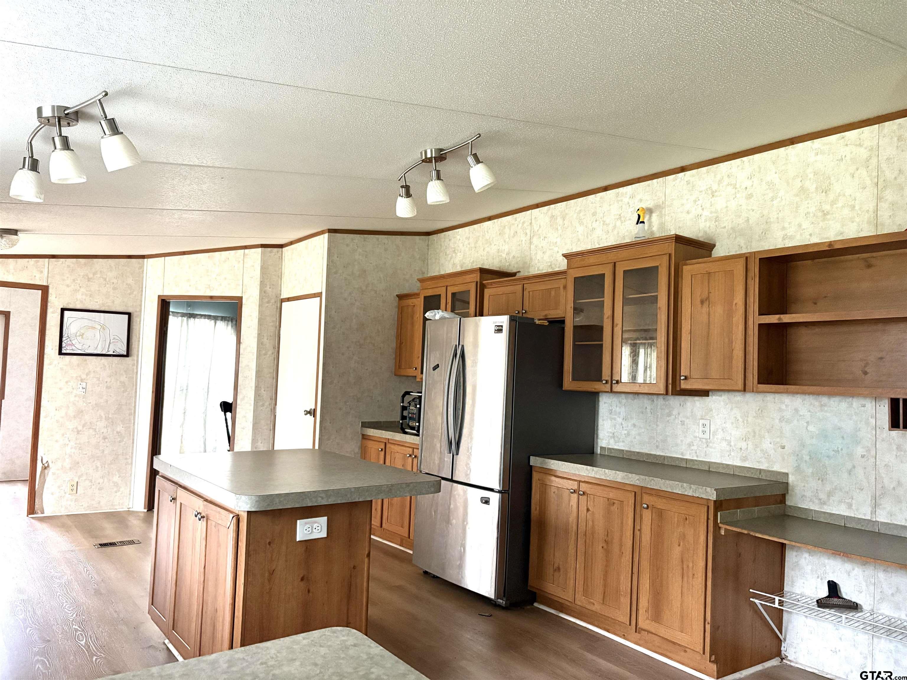 310 Cr 4231 Mount Mount Pleasant, TX 75455 - Photo 13 of 19 a kitchen with stainless steel appliances a refrigerator and wooden floor