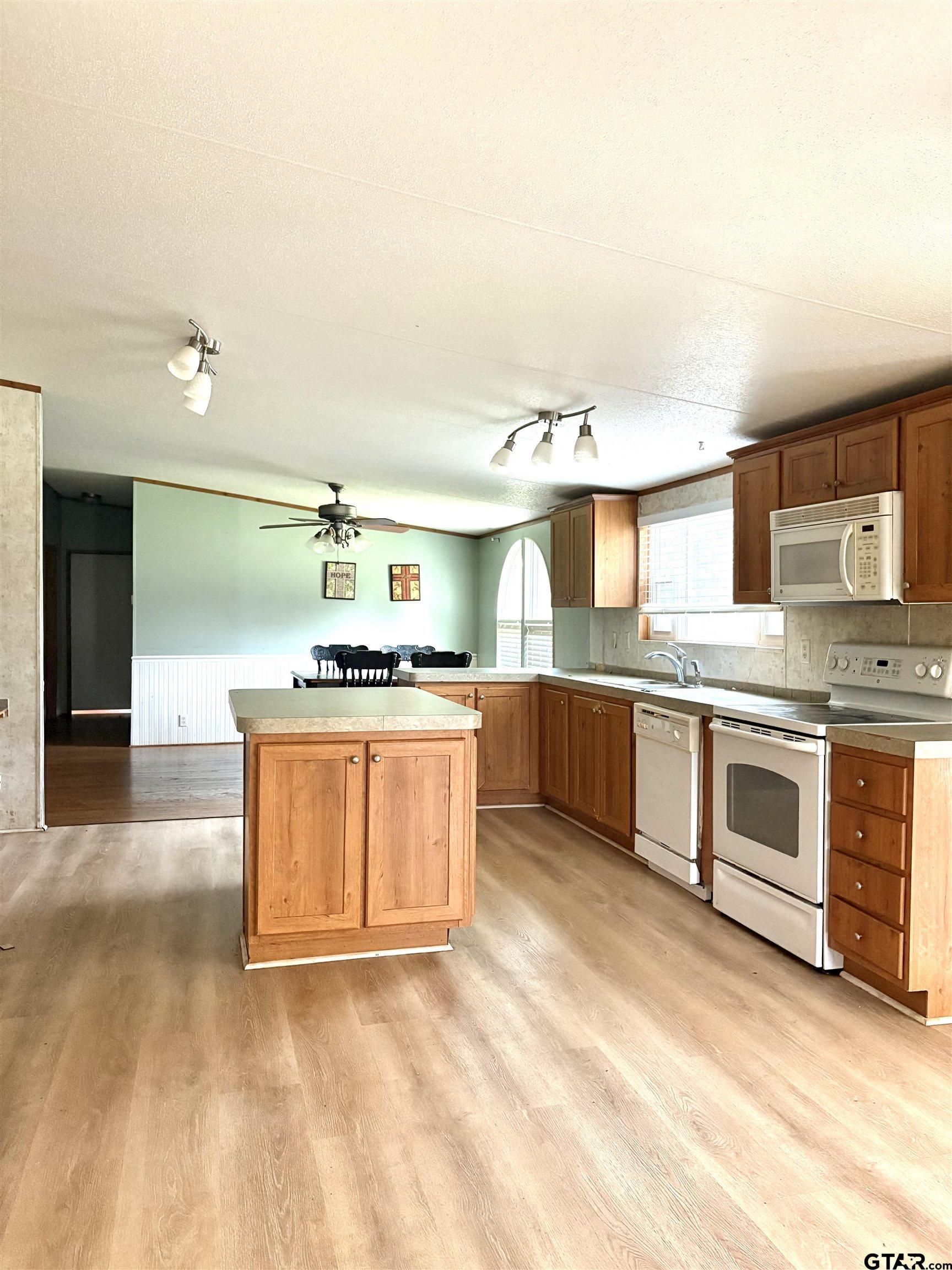 310 Cr 4231 Mount Mount Pleasant, TX 75455 - Photo 14 of 19 a large kitchen with stainless steel appliances granite countertop a stove and a sink