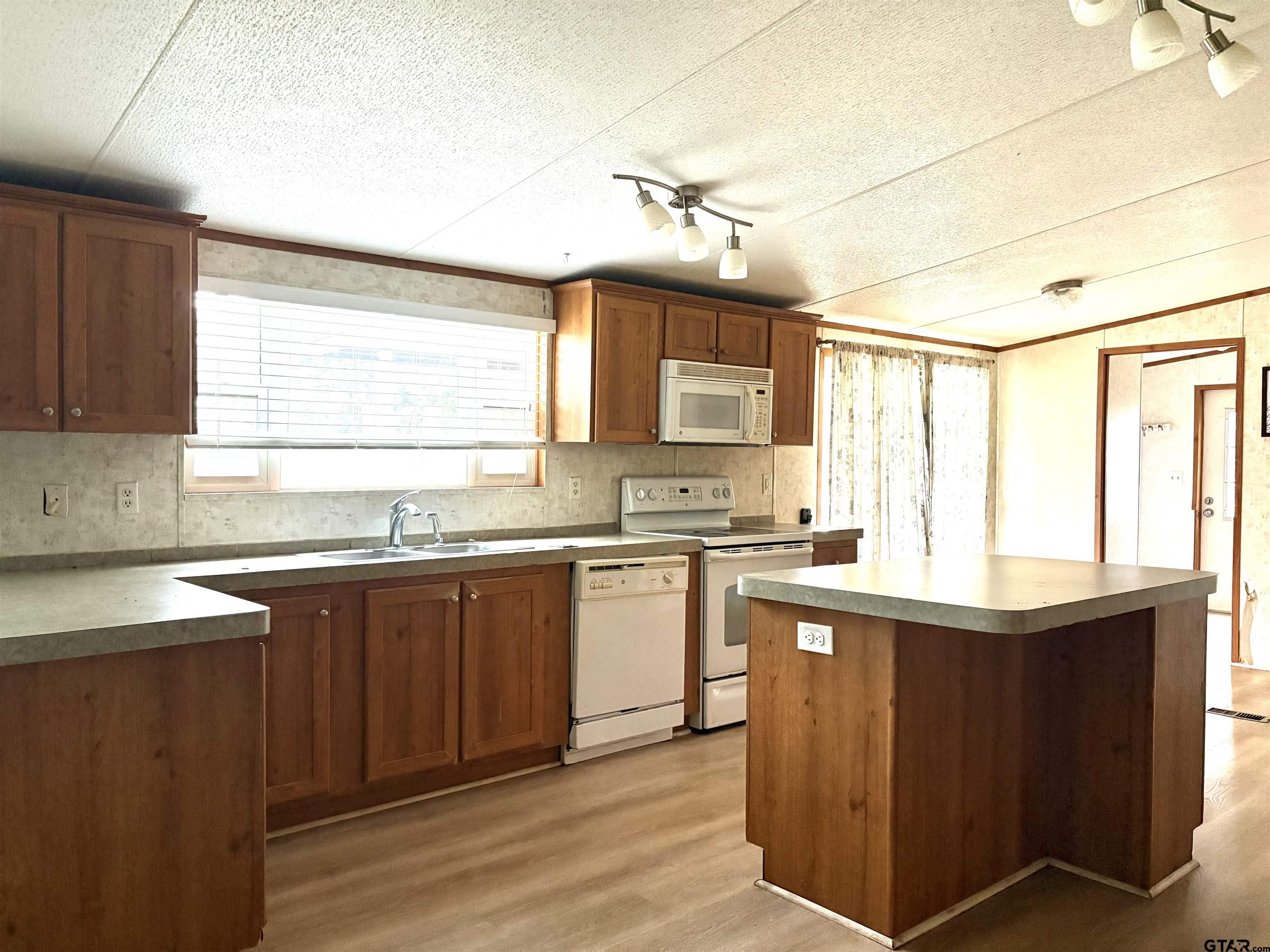 310 Cr 4231 Mount Mount Pleasant, TX 75455 - Photo 14 of 19 a kitchen with granite countertop cabinets stainless steel appliances a sink and a window
