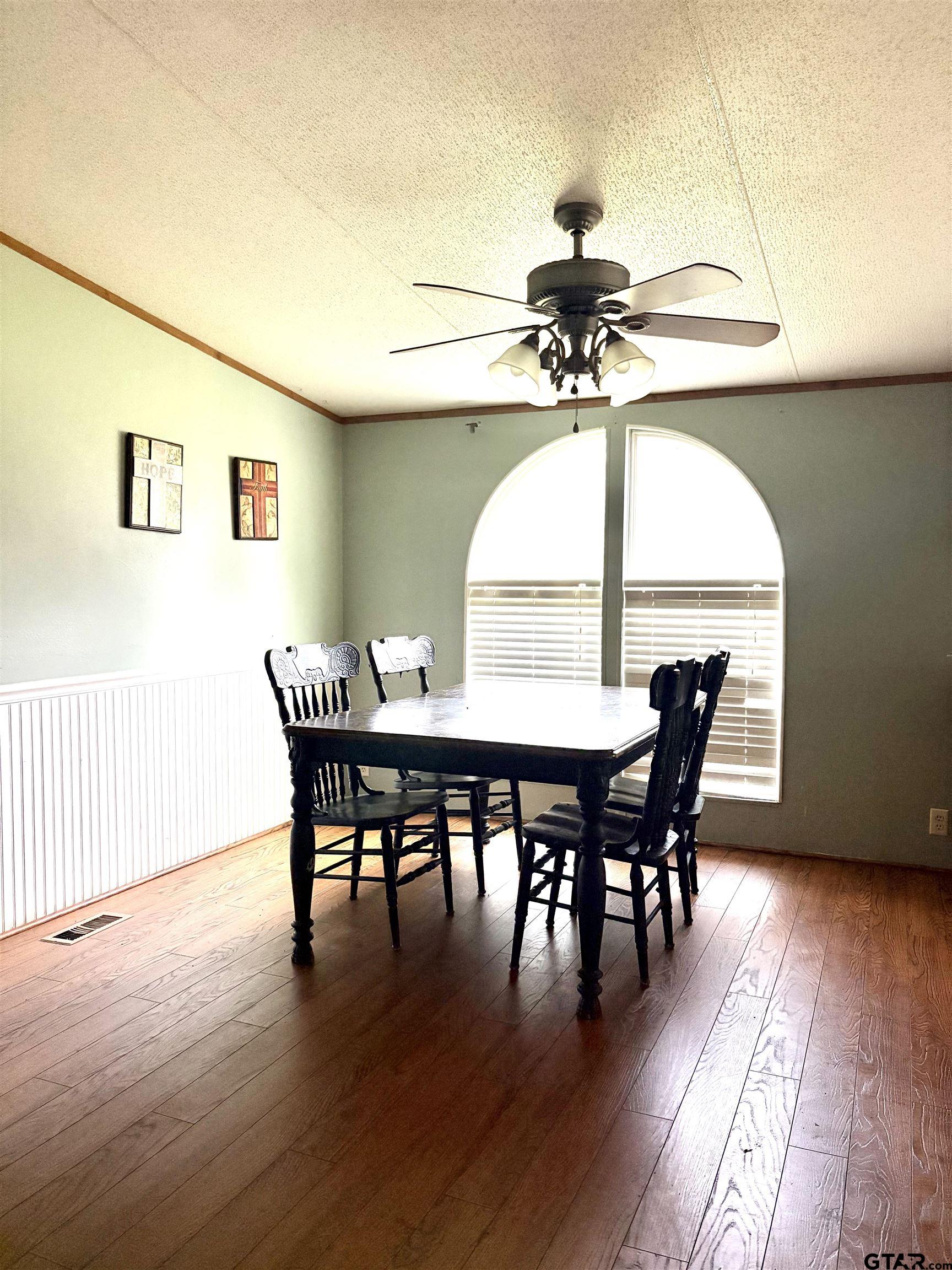 310 Cr 4231 Mount Mount Pleasant, TX 75455 - Photo 17 of 19 a view of a dining room with furniture window and wooden floor