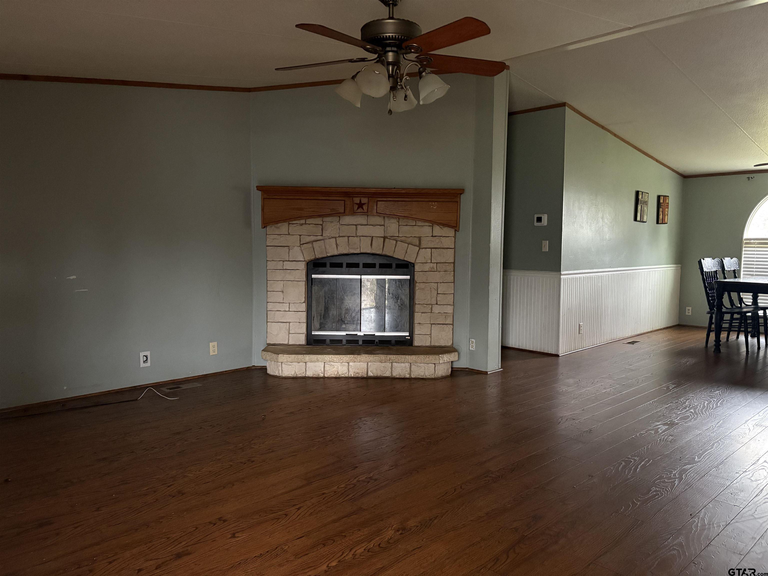 310 Cr 4231 Mount Mount Pleasant, TX 75455 - Photo 18 of 19 a view of a livingroom with a fireplace and wooden floor