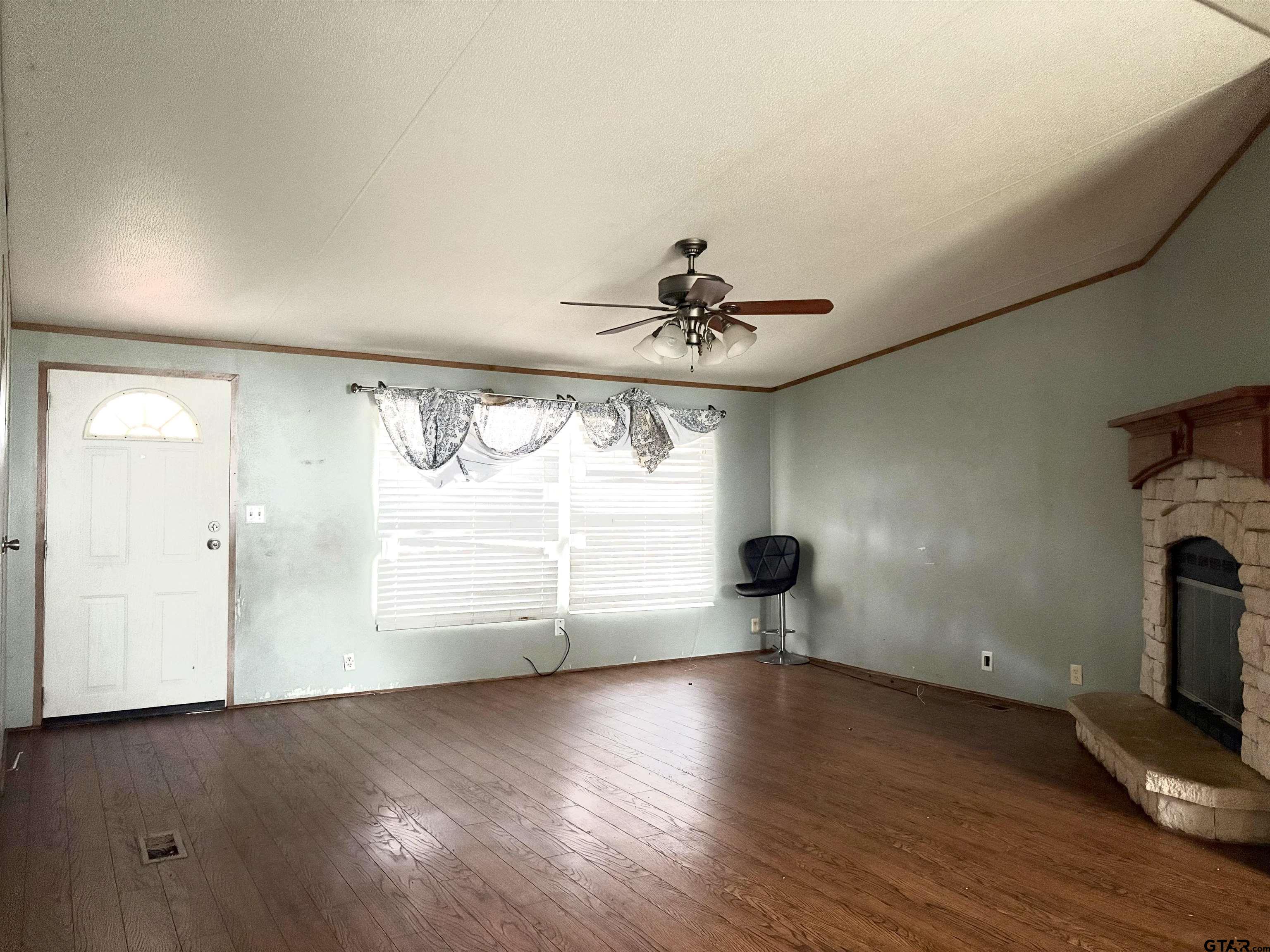 310 Cr 4231 Mount Mount Pleasant, TX 75455 - Photo 18 of 19 a view of empty room with wooden floor and fan