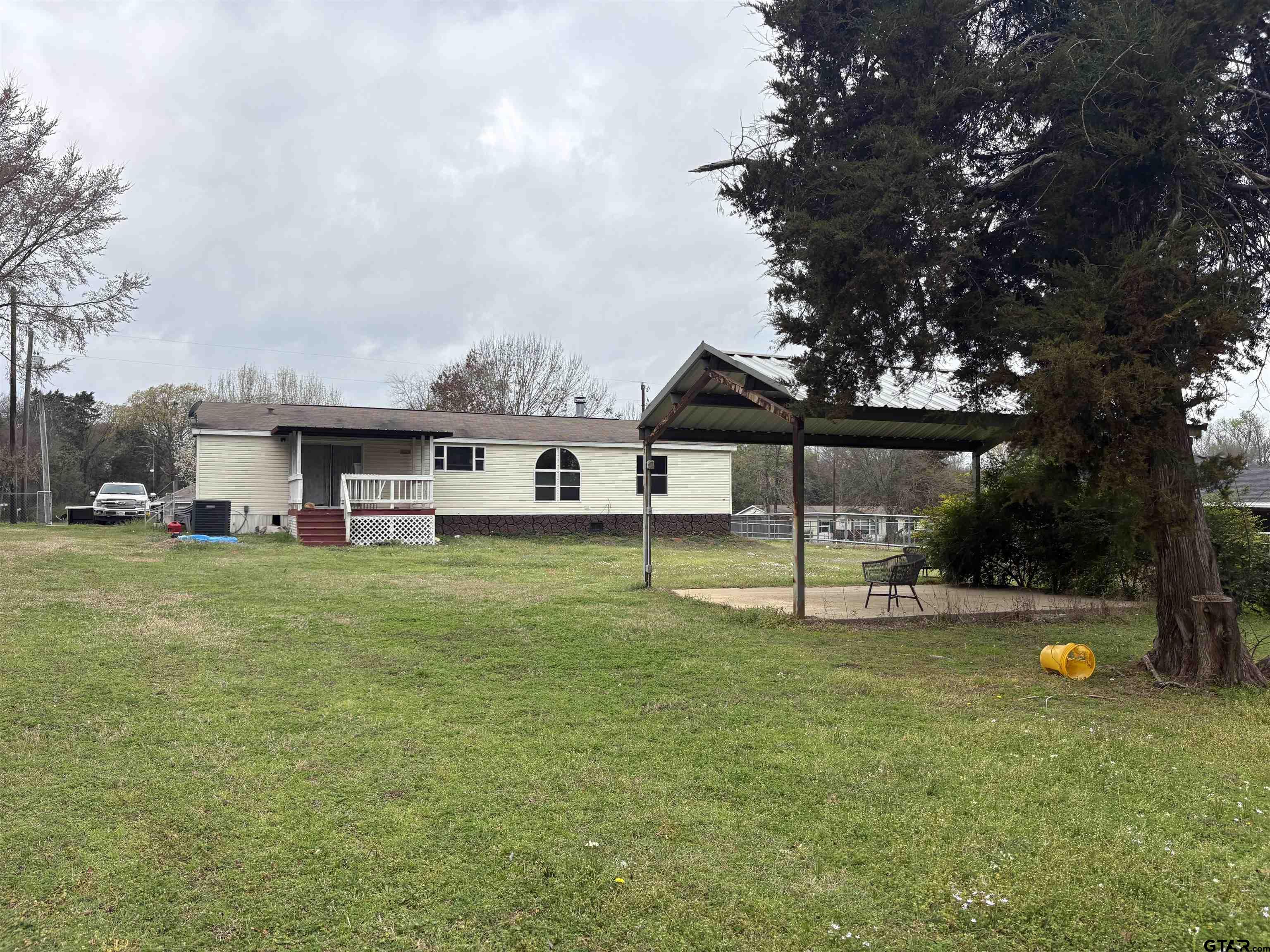 310 Cr 4231 Mount Mount Pleasant, TX 75455 - Photo 2 of 19 a view of a house with a backyard porch and sitting area