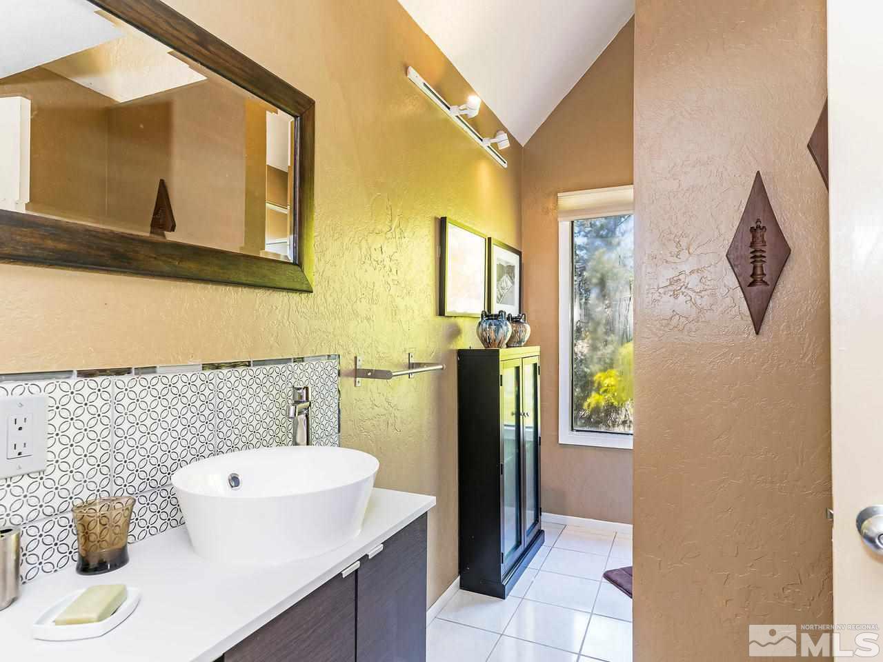 14748 Pine Knolls Lane Reno, NV 89521 - Photo 17 of 33 a bathroom with a sink and a mirror