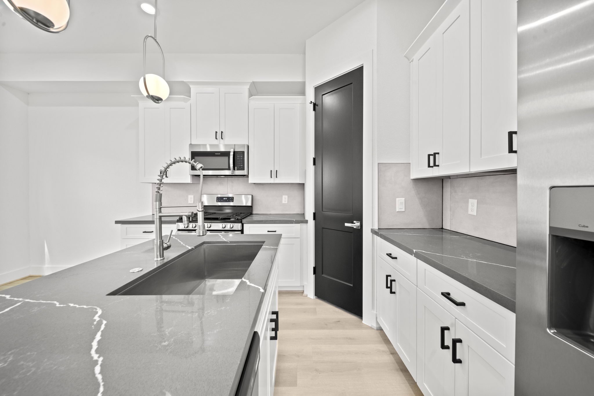 a kitchen with cabinets and stainless steel appliances