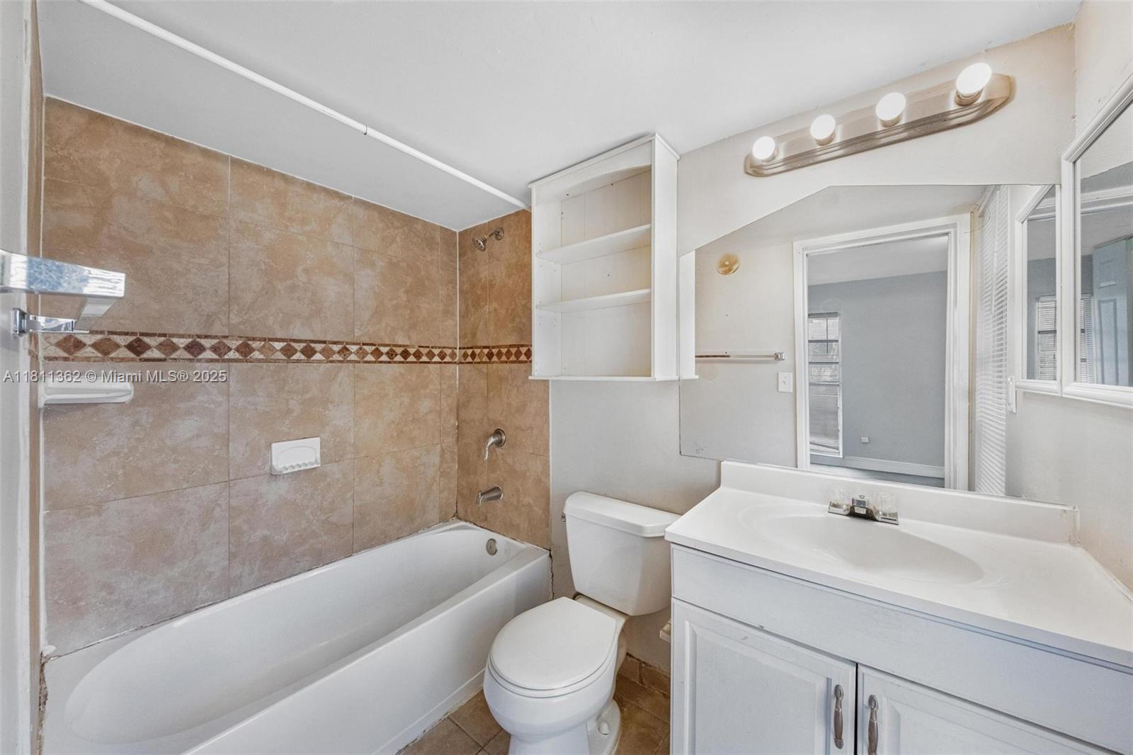 7019 Northwest 63rd Street Tamarac, FL 33321 - Photo 12 of 33 a bathroom with a sink a toilet and shower