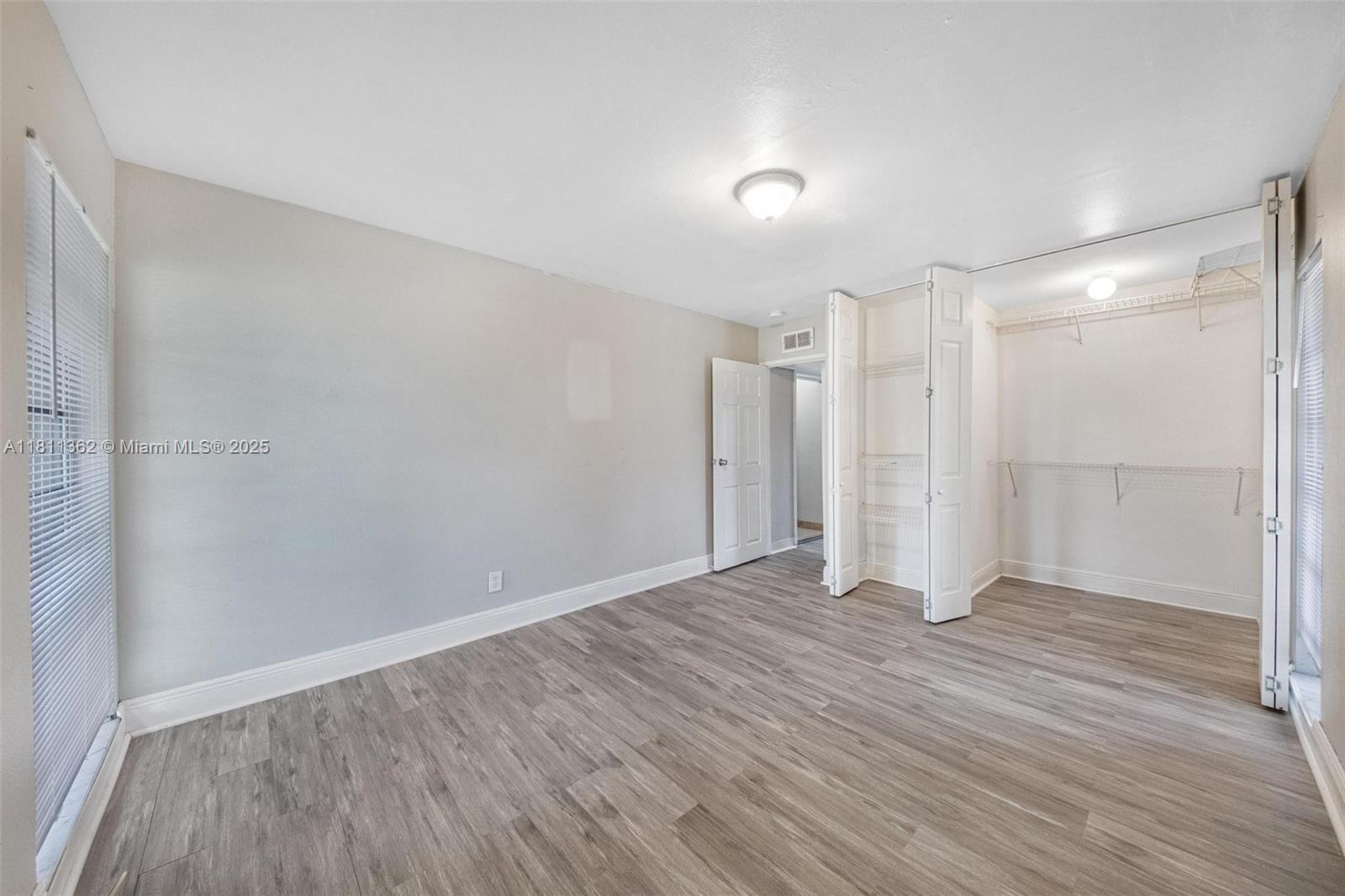 7019 Northwest 63rd Street Tamarac, FL 33321 - Photo 13 of 33 a view of an empty room with wooden floor
