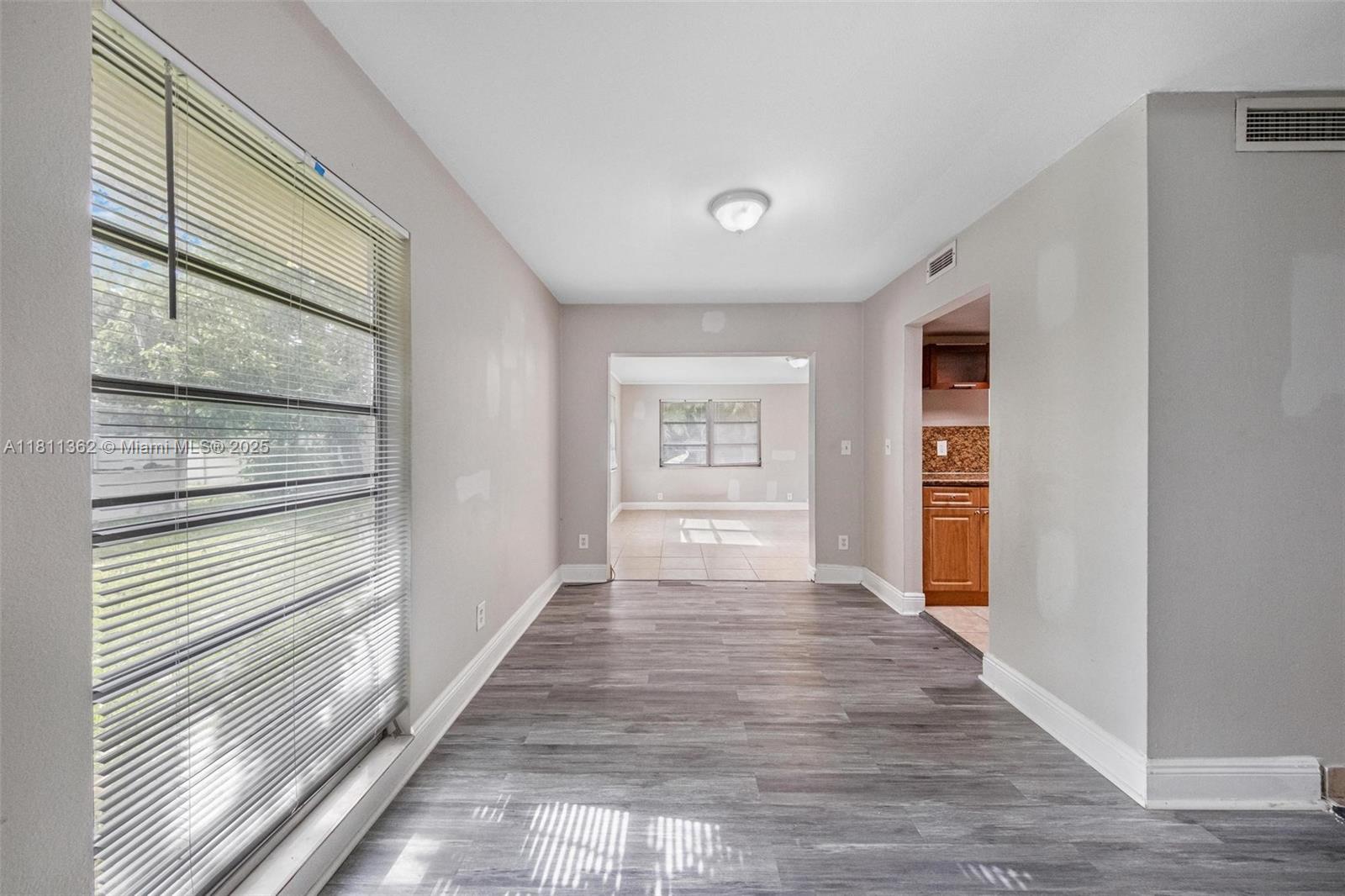 7019 Northwest 63rd Street Tamarac, FL 33321 - Photo 17 of 33 a view of an entryway with wooden floor