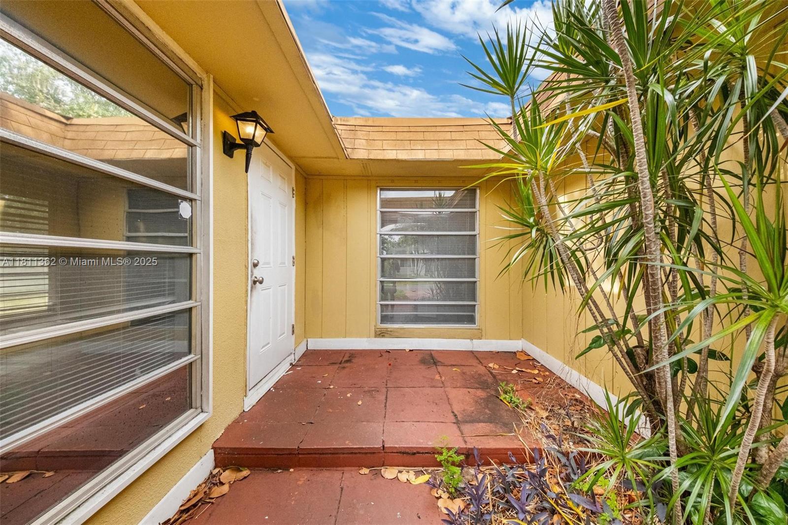 7019 Northwest 63rd Street Tamarac, FL 33321 - Photo 2 of 33 a view of a backyard with a small cabin