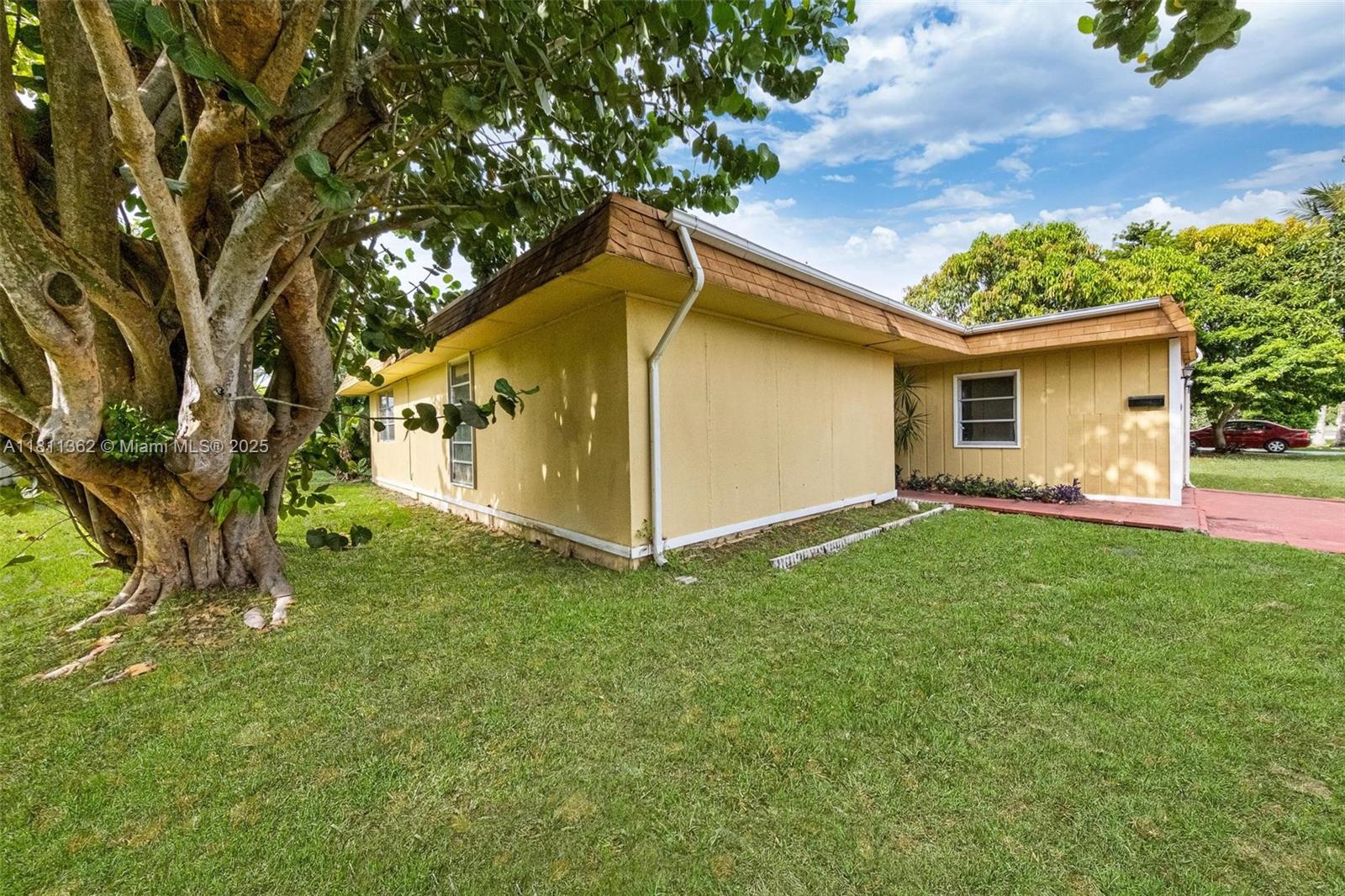 7019 Northwest 63rd Street Tamarac, FL 33321 - Photo 27 of 33 a backyard of a house with lots of green space