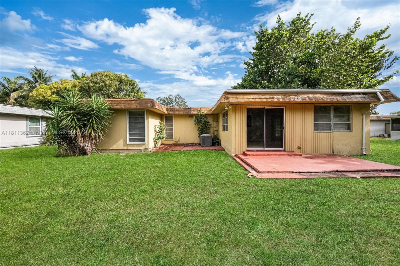 7019 Northwest 63rd Street Tamarac, FL 33321 - Photo 28 of 33 a view of a house with a yard and plants