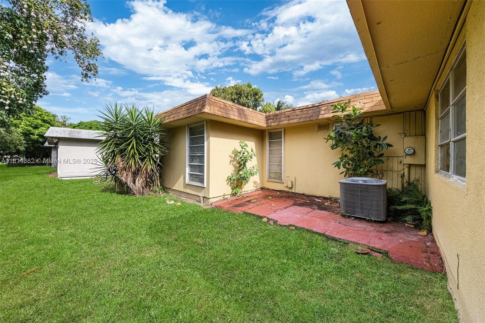 7019 Northwest 63rd Street Tamarac, FL 33321 - Photo 30 of 33 a view of a house with backyard and garden
