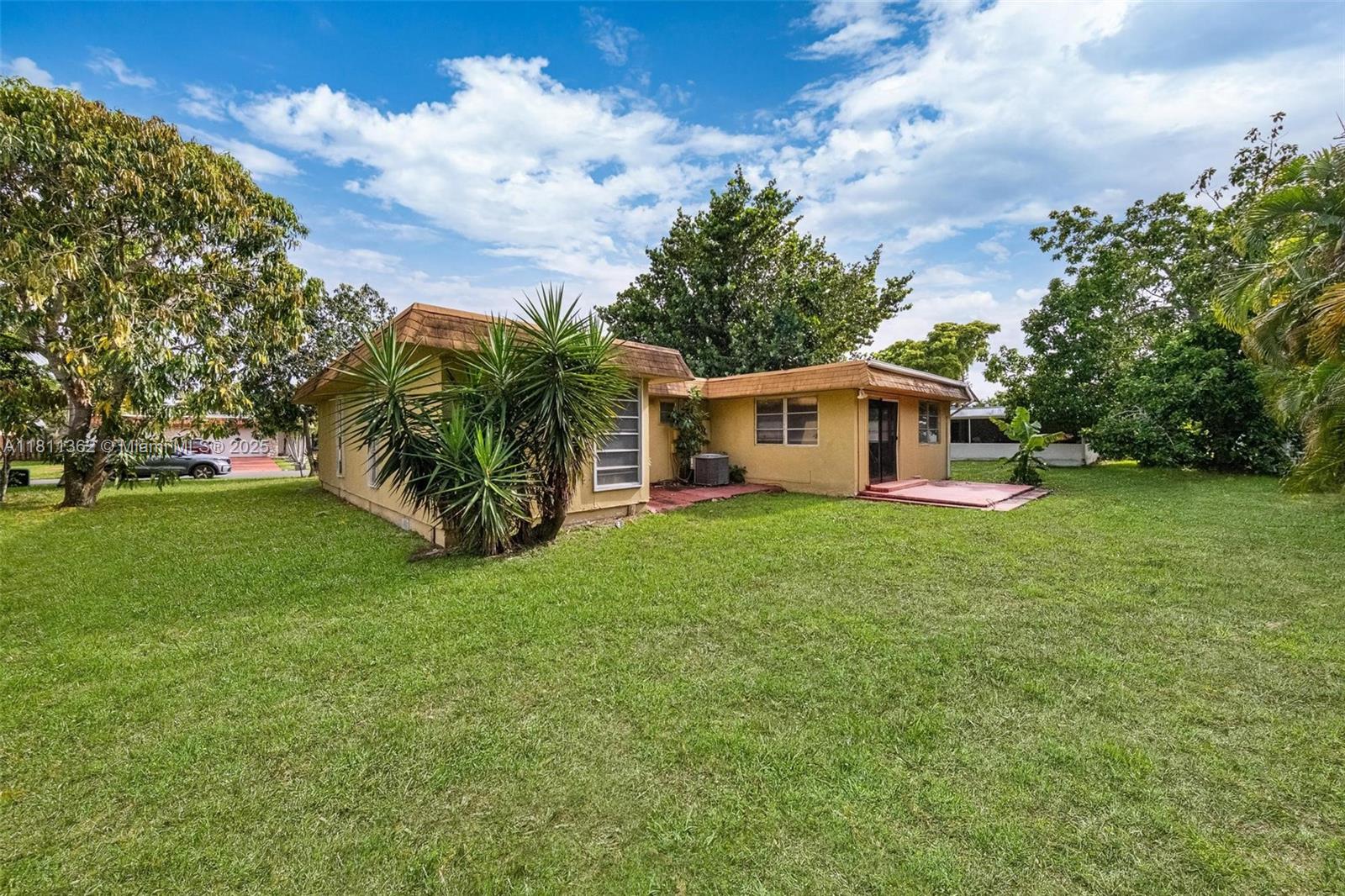 7019 Northwest 63rd Street Tamarac, FL 33321 - Photo 31 of 33 a view of a house with backyard and garden