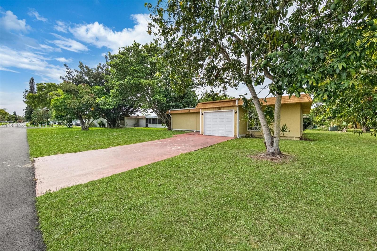 7019 Northwest 63rd Street Tamarac, FL 33321 - Photo 32 of 33 a view of a house with a yard