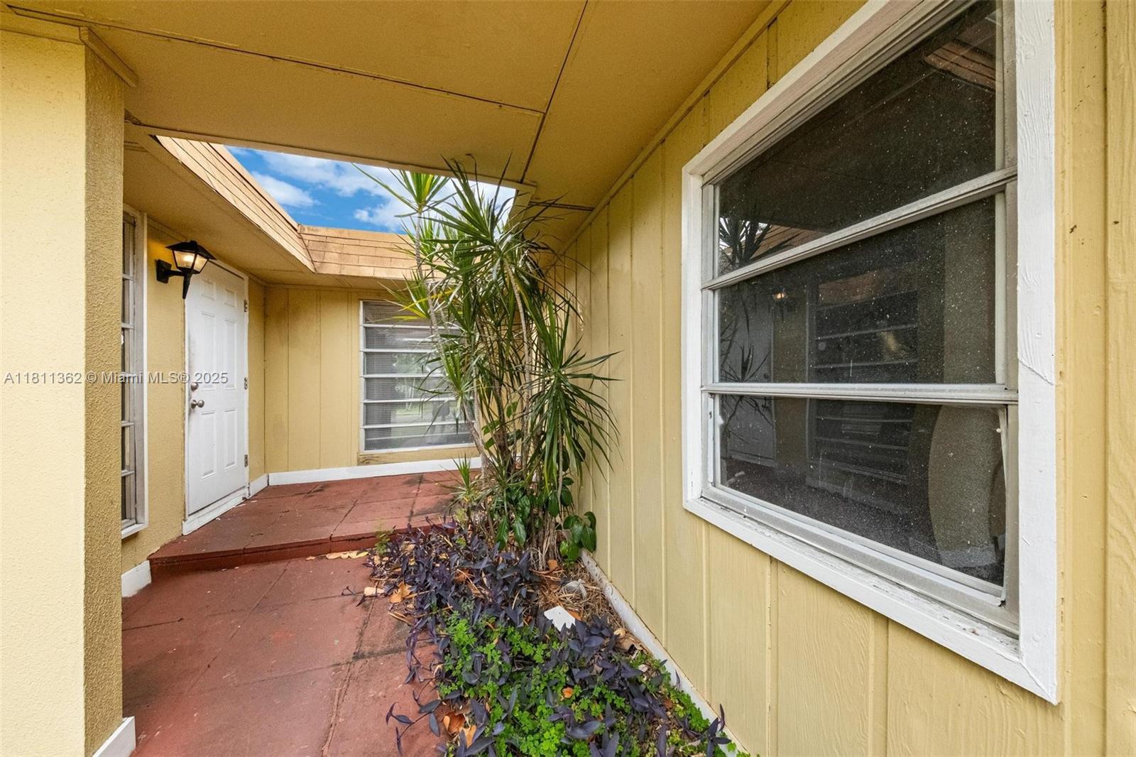 7019 Northwest 63rd Street Tamarac, FL 33321 - Photo 33 of 33 a house with a window