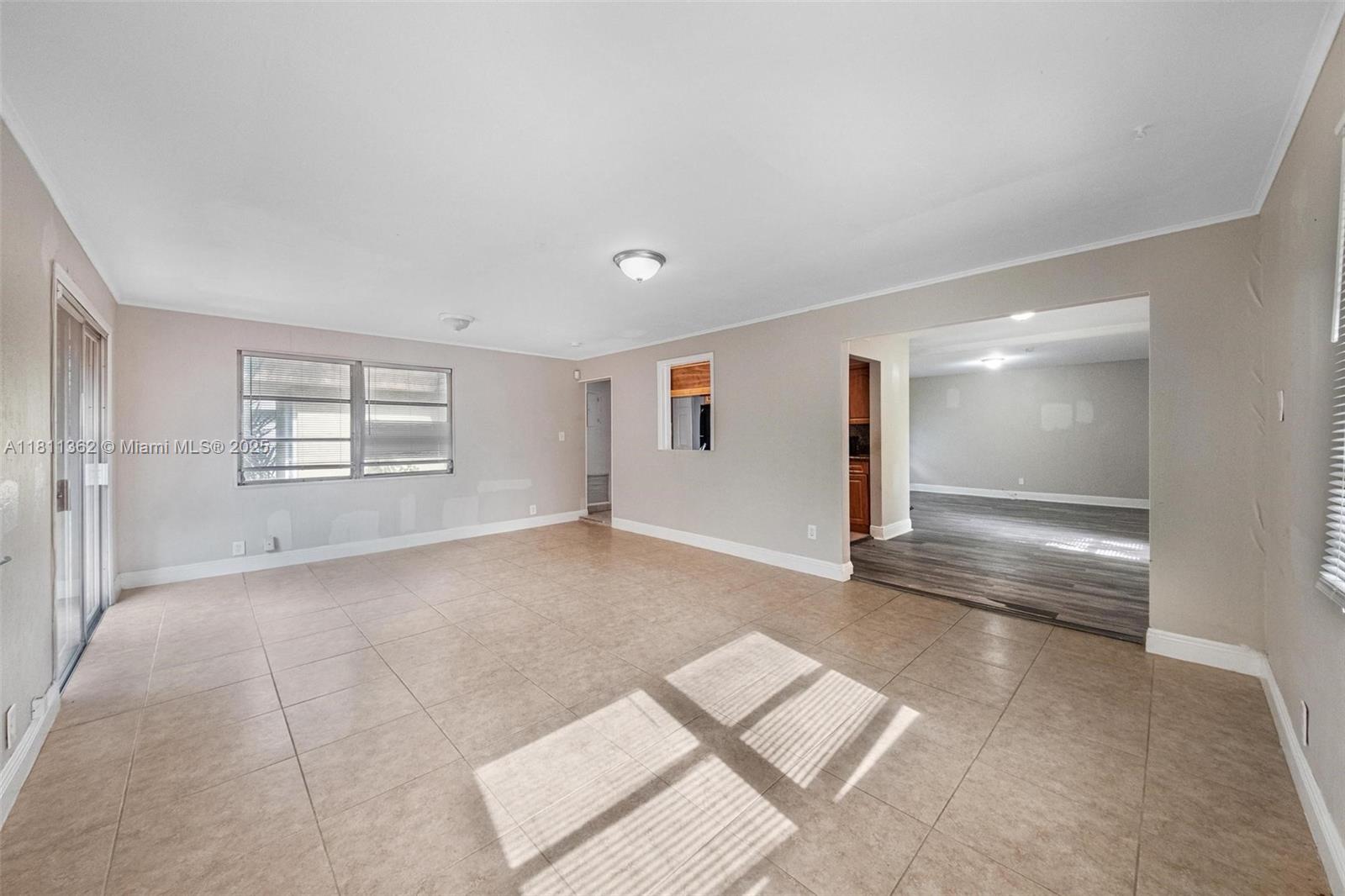 7019 Northwest 63rd Street Tamarac, FL 33321 - Photo 5 of 33 a view of an empty room with a window