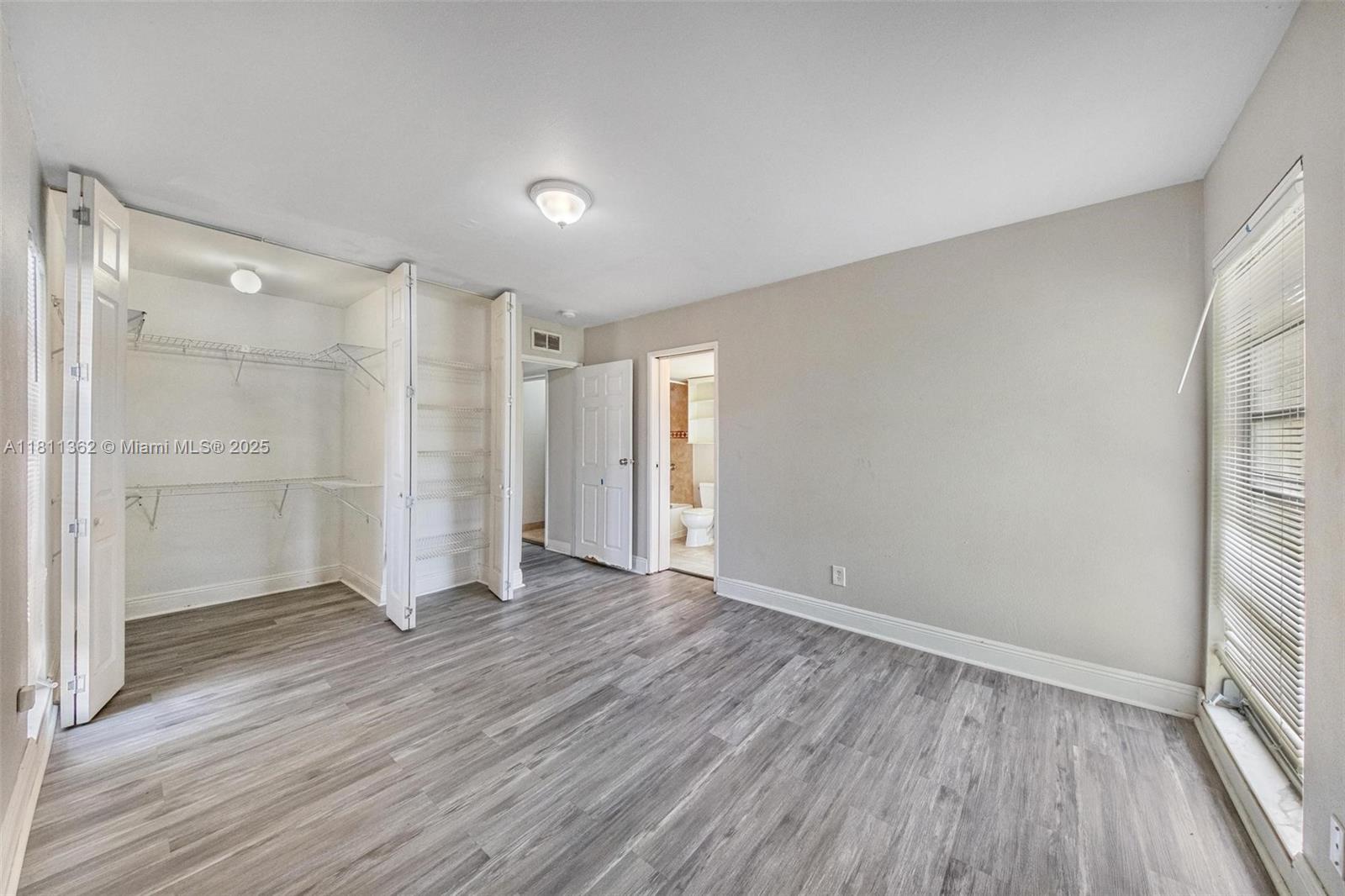 7019 Northwest 63rd Street Tamarac, FL 33321 - Photo 10 of 33 a view of an empty room with wooden floor and a window