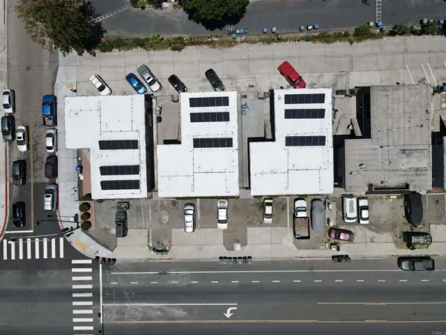 a view of building with cars parked