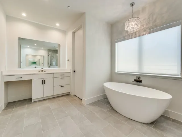 a spacious bathroom with a double vanity sink a mirror and a bathtub