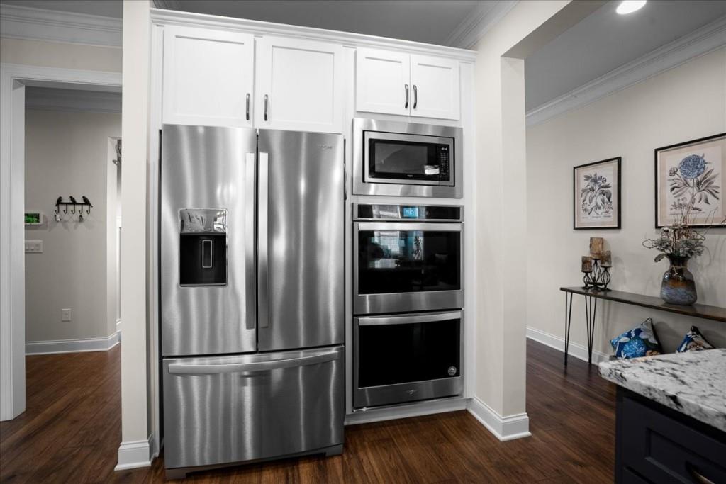 641 Haven Way Monroe, GA 30655 - Photo 11 of 55 a kitchen with stainless steel appliances and wooden floor