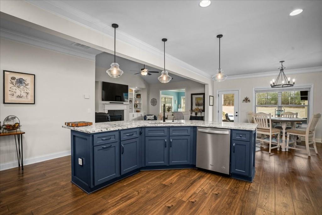 641 Haven Way Monroe, GA 30655 - Photo 12 of 55 a kitchen with stainless steel appliances granite countertop wooden floors and white cabinets