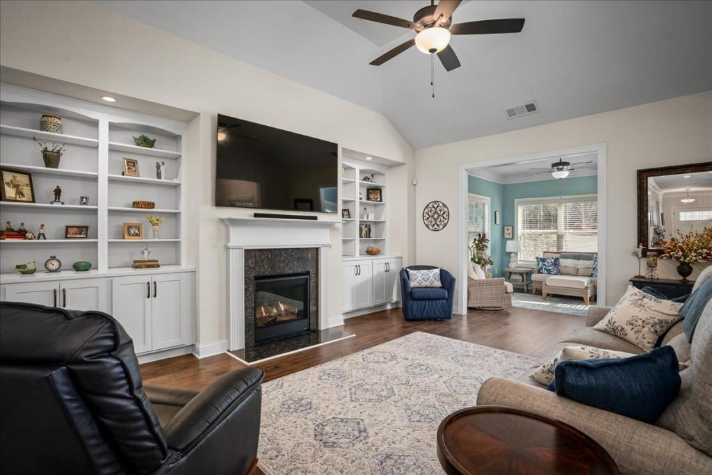 641 Haven Way Monroe, GA 30655 - Photo 14 of 55 a living room with furniture a flat screen tv and a fireplace