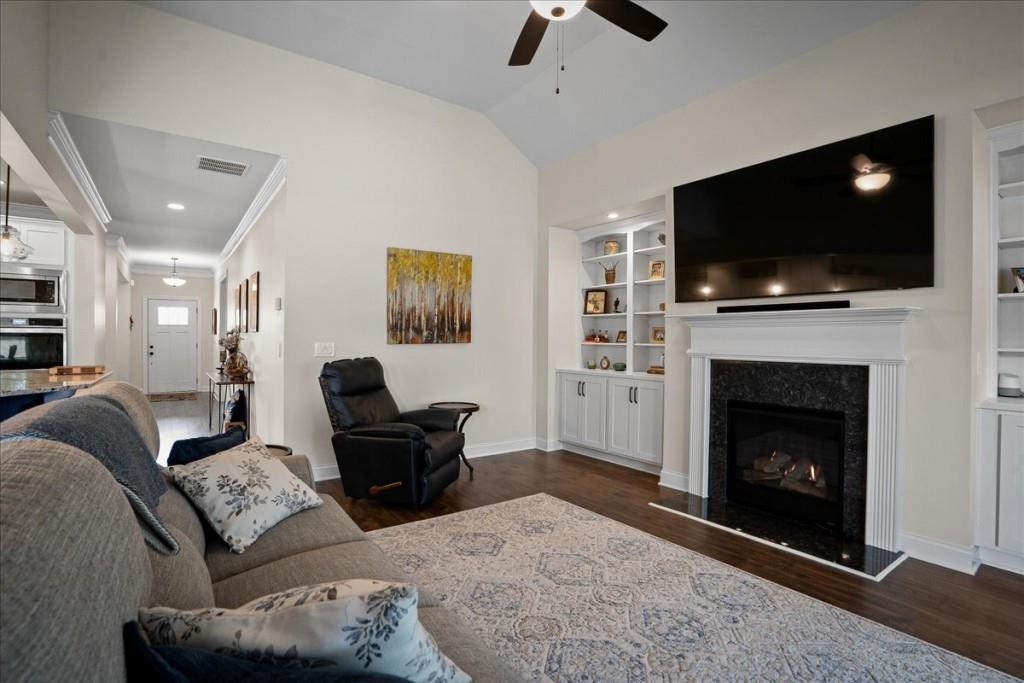 641 Haven Way Monroe, GA 30655 - Photo 15 of 55 a living room with furniture a flat screen tv and a fireplace