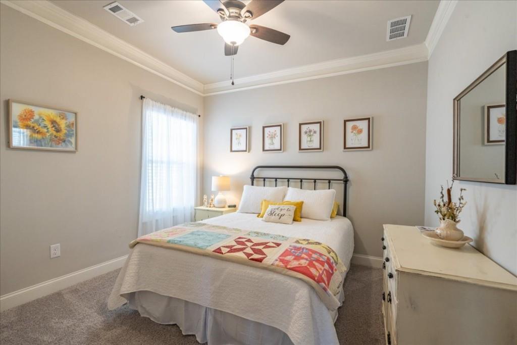 641 Haven Way Monroe, GA 30655 - Photo 28 of 55 a bedroom with a large bed and a chandelier
