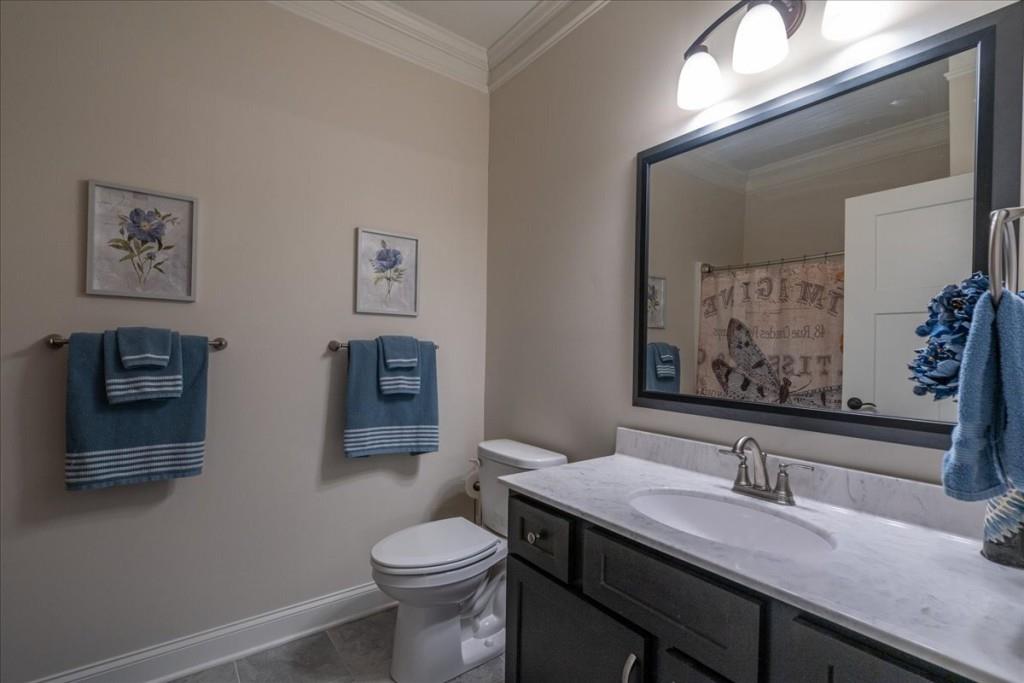 641 Haven Way Monroe, GA 30655 - Photo 29 of 55 a bathroom with a granite countertop sink and a toilet