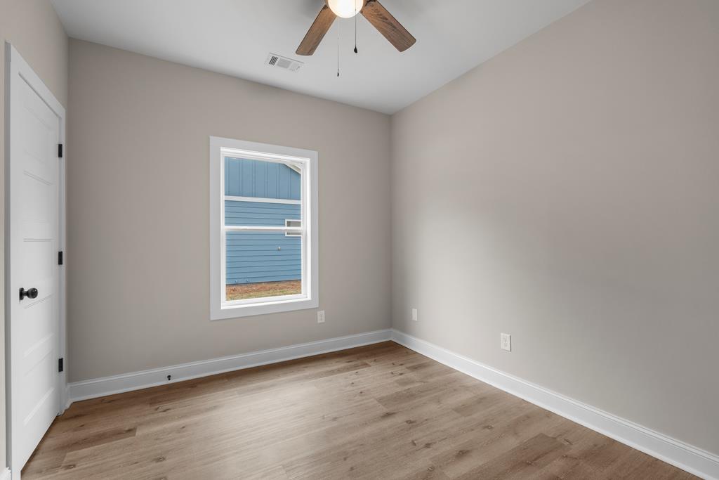 400 Burns Avenue Pine Mountain, GA 31822 - Photo 12 of 16 an empty room with a window and a ceiling fan
