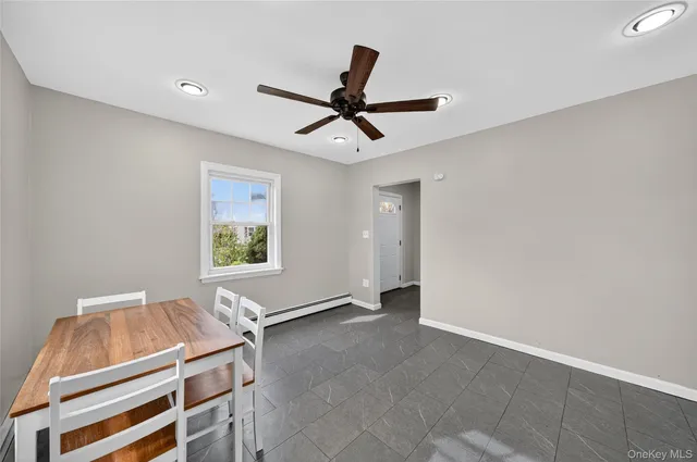 a room with table and ceiling fan