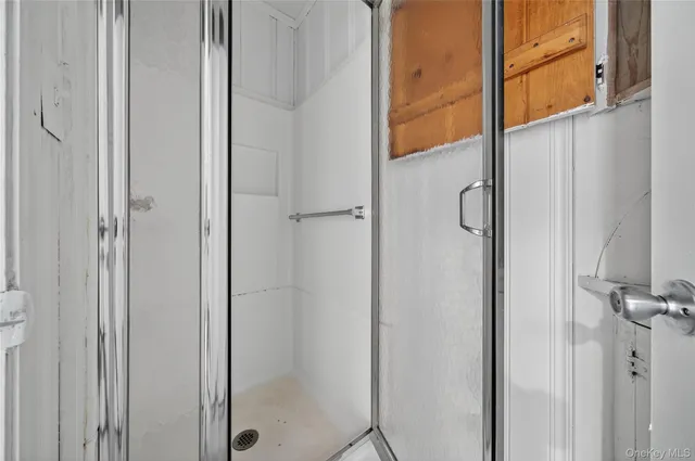 a bathroom with a glass shower door