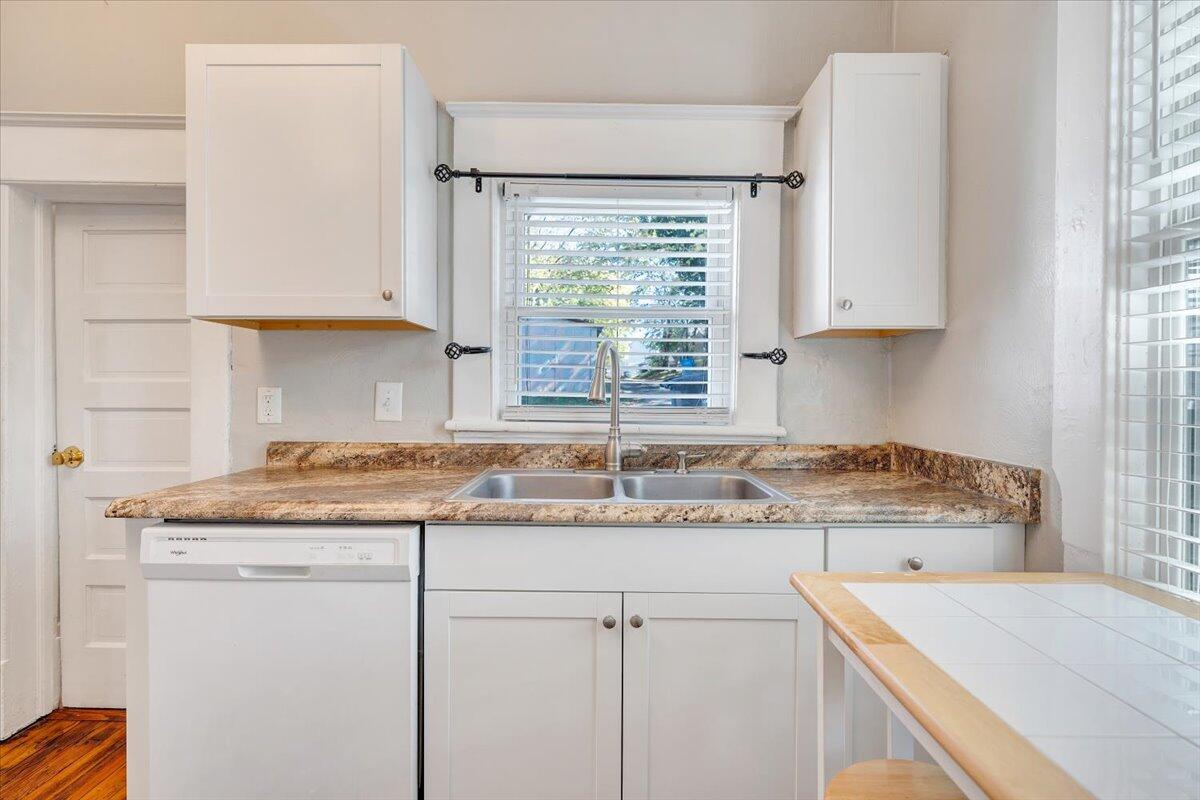 1008 5th Street Southeast Roanoke, VA 24013 - Photo 18 of 60 a kitchen with granite countertop a sink window and cabinets
